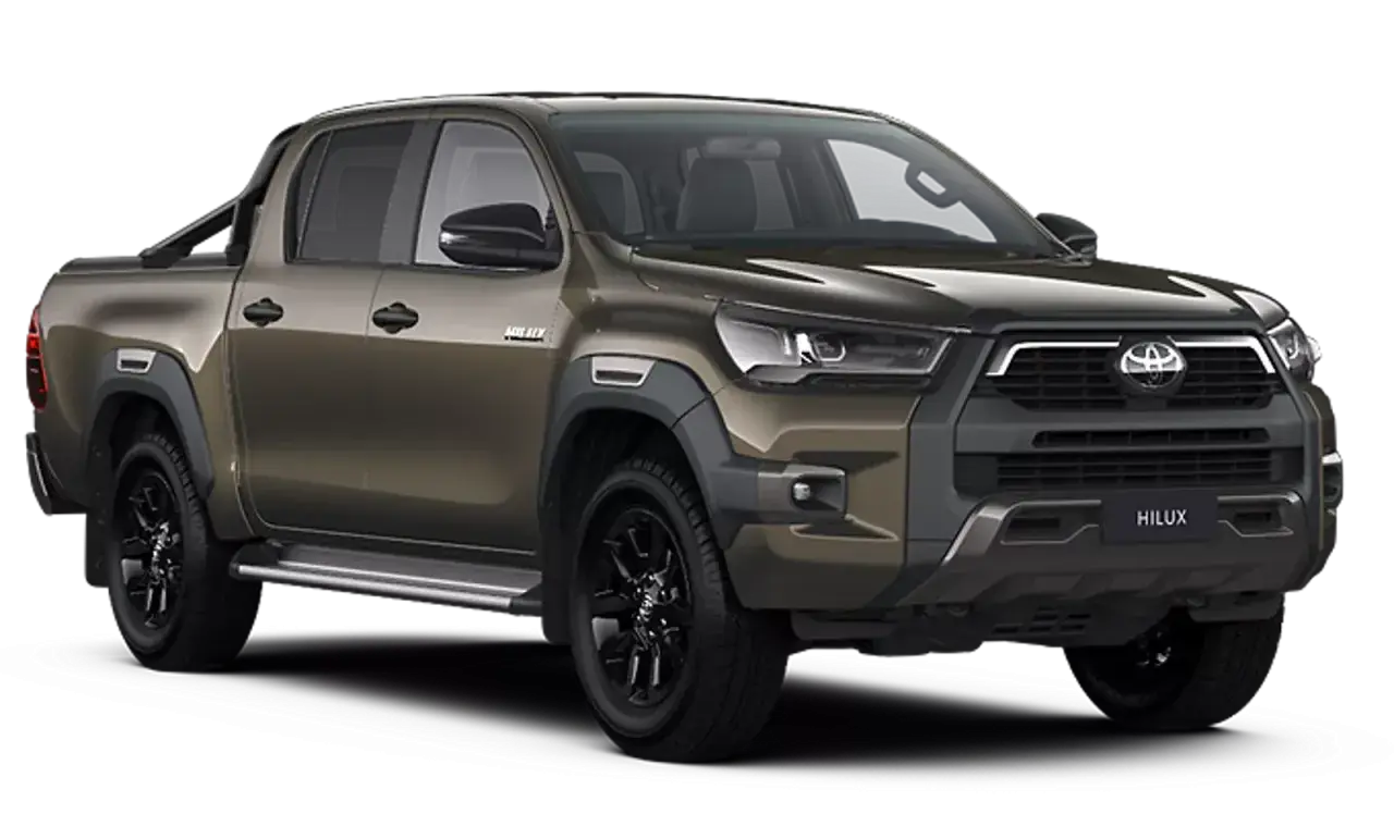Brązowy Toyota Hilux z czarnymi felgami i relingami. Sprawdź aktualną toyota hilux cena i zamów swój wymarzony samochód.