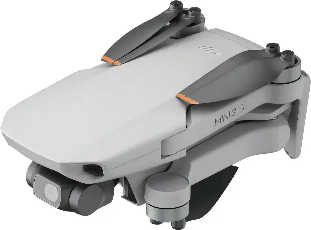 Składany dron DJI Mini 2 SE z kamerą i pomarańczowymi akcentami na śmigłach. Idealny do nauki trików w powietrzu.
