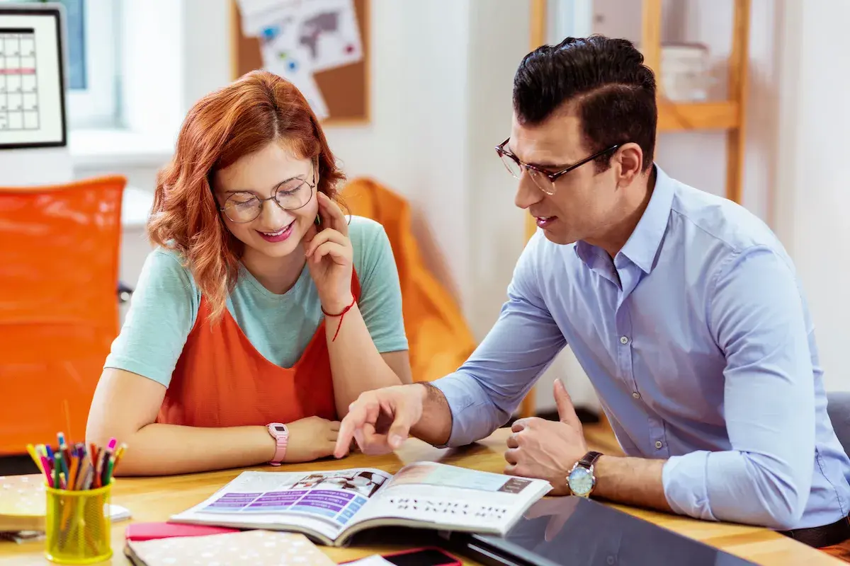 Ragazza e ragazzo studiano insieme, lui indica qualcosa sul libro. Ci sono molte frasi interessanti da scoprire.