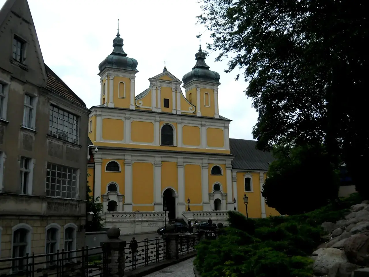 Franciszkowie Poznań wzgórze Przemysła. Żółty kościół z zielonymi kopułami góruje nad miastem.