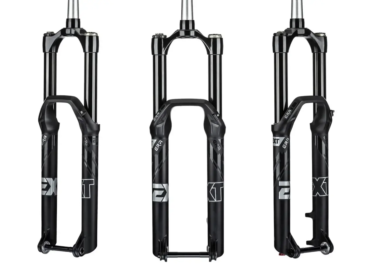 Three black EXT era bicycle forks are displayed.