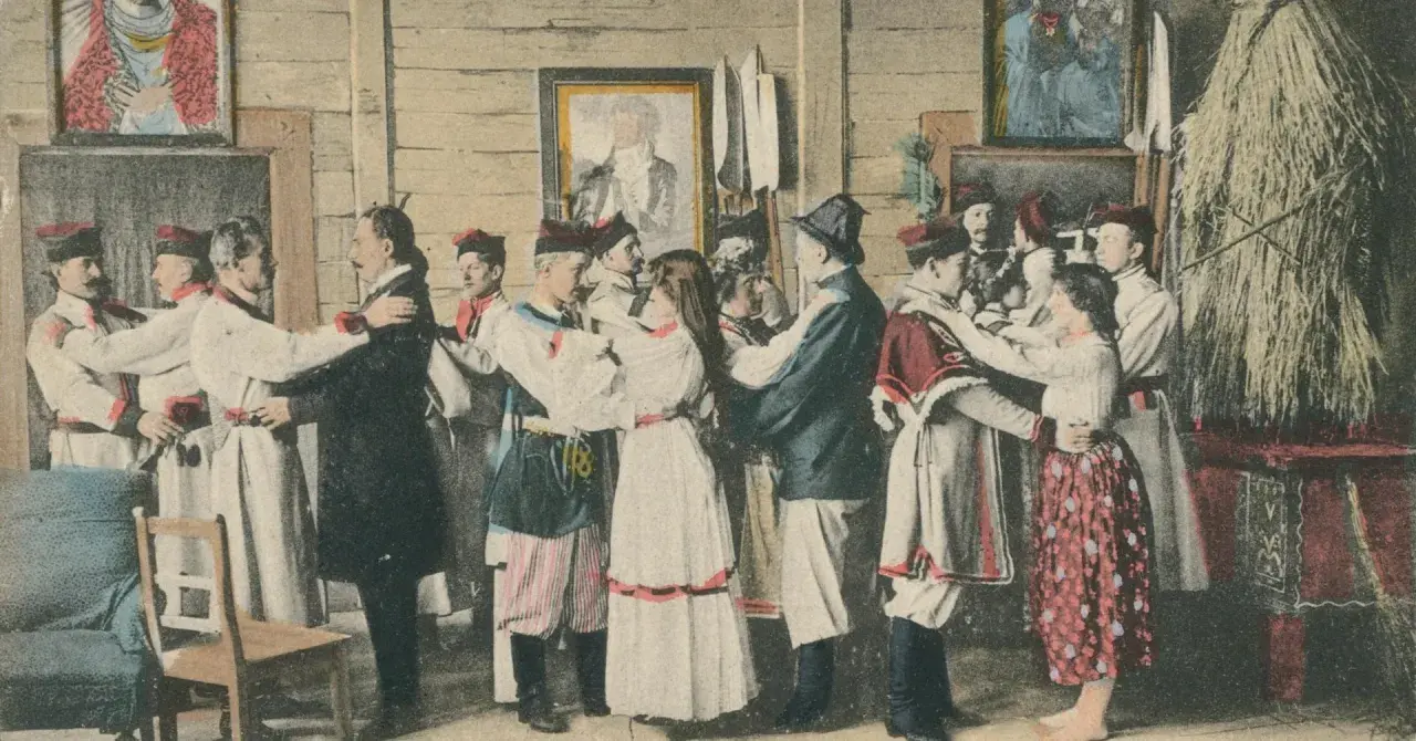 Scena weselna w stylu Wyspiańskiego. Ludzie w strojach ludowych tańczą, a na ścianach wiszą obrazy.