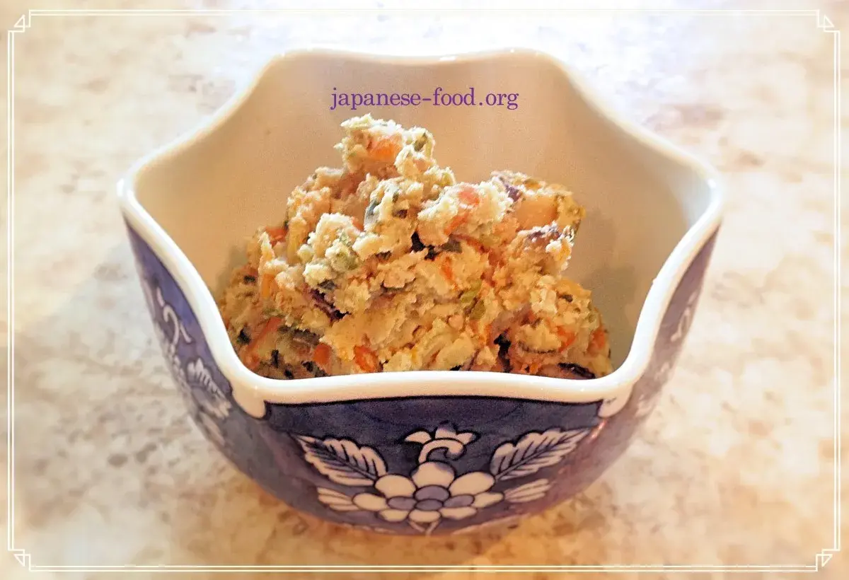 A bowl of okara salad, a healthy dish from okara recipes, filled with chopped vegetables like carrots and green beans.