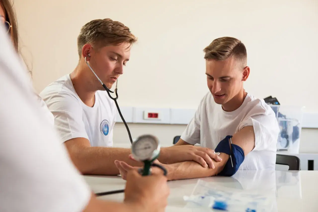 Opiekun medyczny mierzy ciśnienie, wspierając promocję zdrowia i profilaktykę.