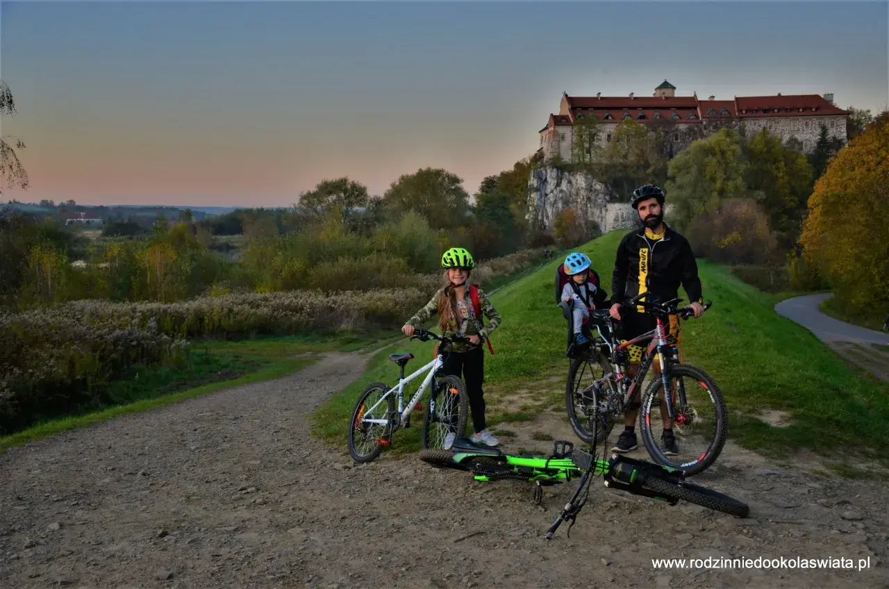 Rodzina na rowerach pod zamkiem, odkrywają malownicze trasy rowerowe Małopolska.