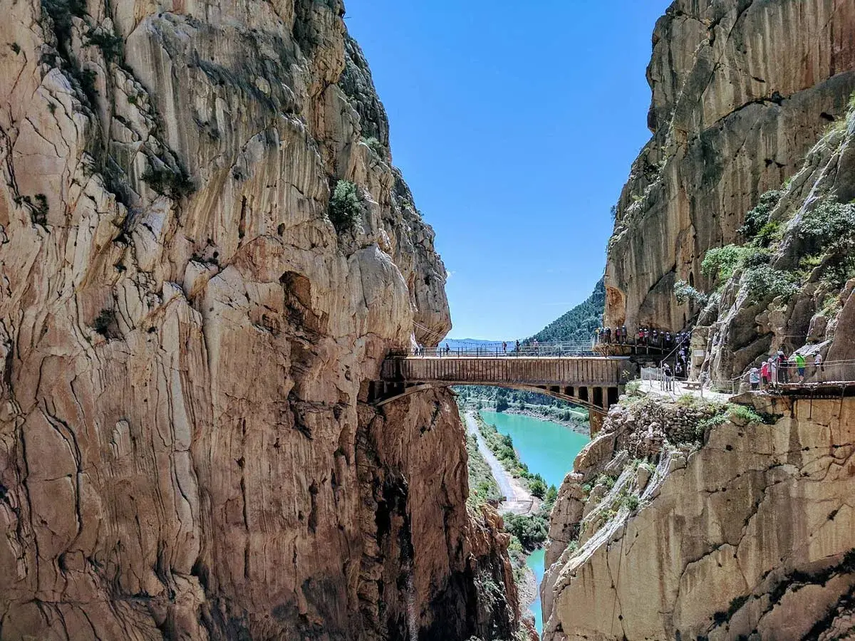 Niesamowity Caminito del Rey, ścieżka króla, wije się wśród stromych klifów nad turkusową rzeką.