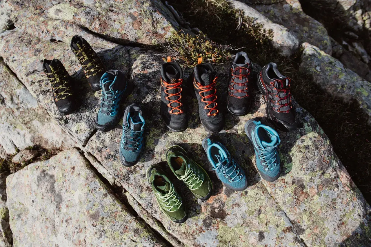 A collection of hiking boots and shoes in various colors, arranged on rocks. Even well-made shoes can degrade over time if not worn, a process that can seem mysterious.
