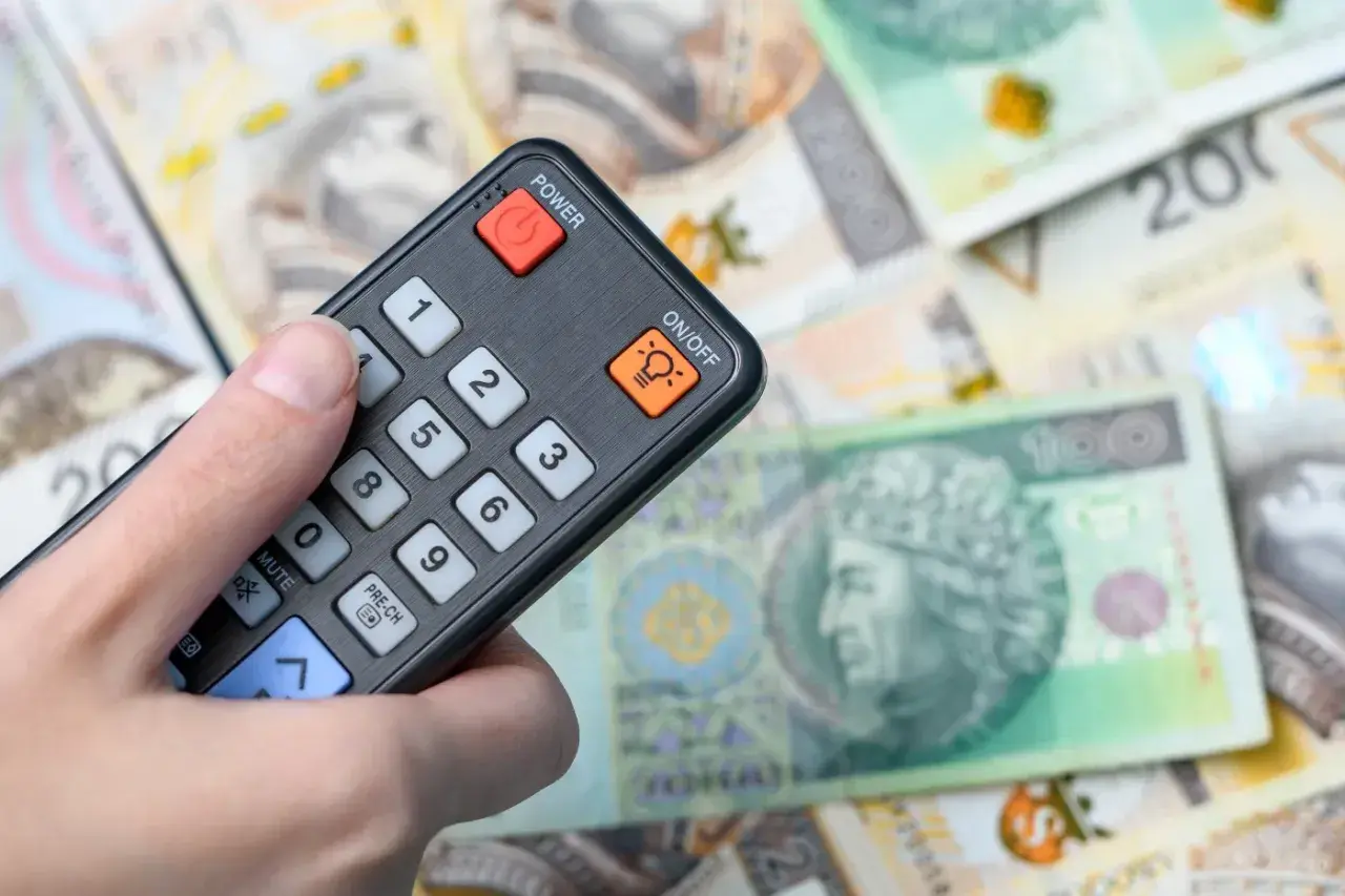 Pilot w dłoni, a pod nim polskie banknoty. Czy to zapowiedź, że abonament RTV 2026 za cały rok będzie kosztował tyle co te pieniądze?