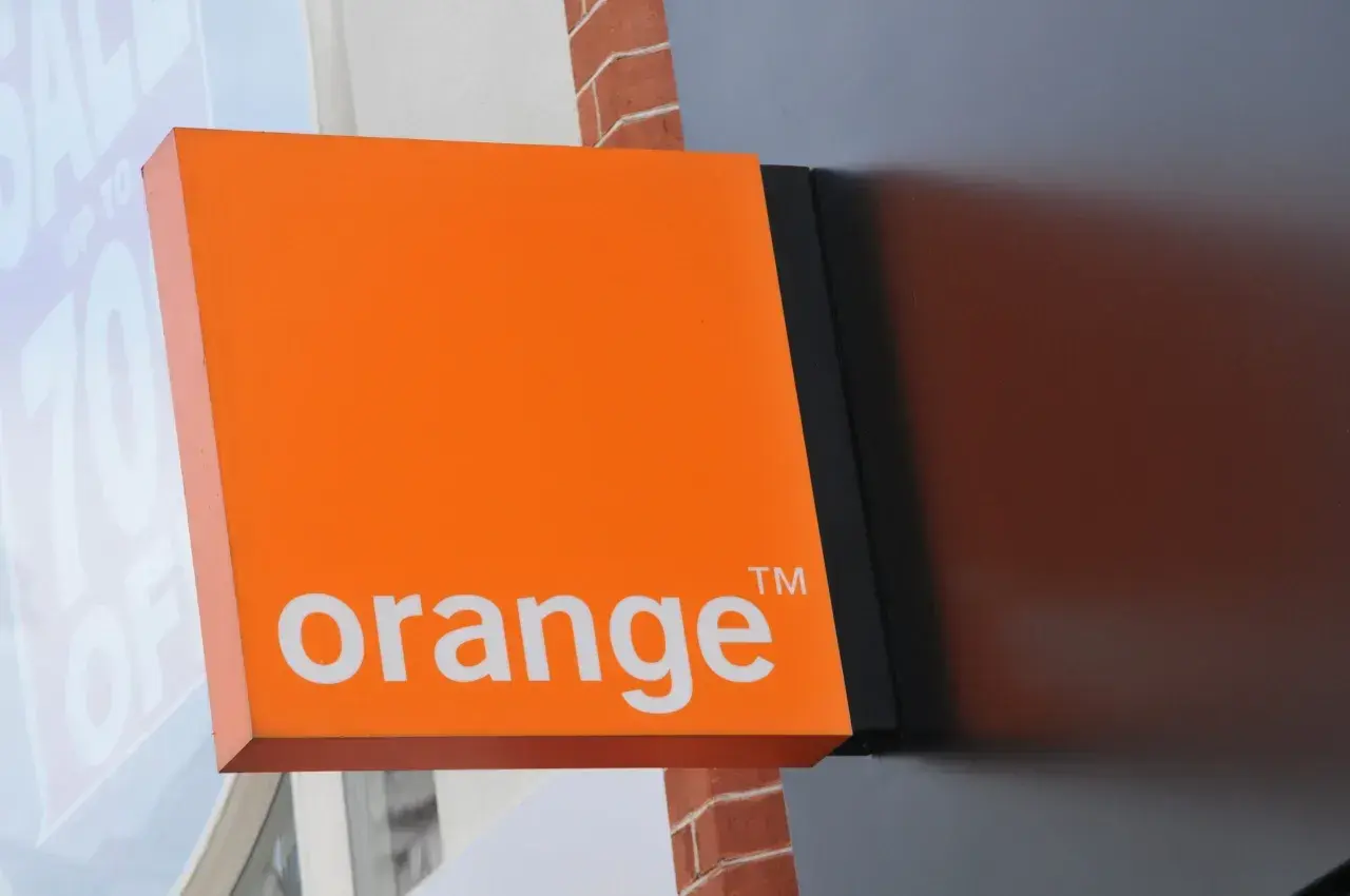 Pomarańczowy szyld Orange z logo. Może tam jest poczta głosowa Orange?