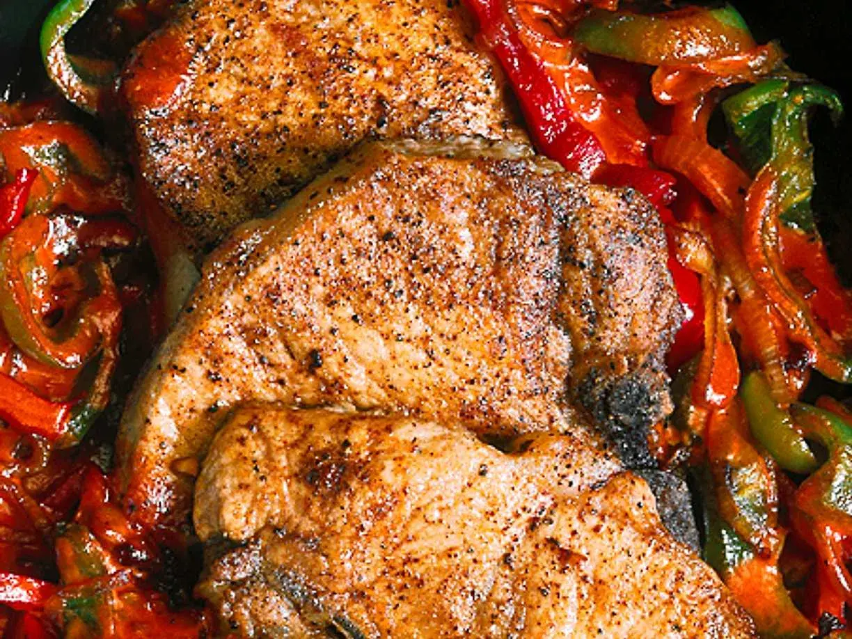 Saftiga kotletter i ugn med paprika och lök. En härlig middag som doftar underbart.
