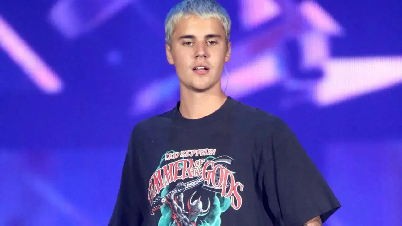 Justin Bieber z niebieskimi włosami na scenie, w koszulce z napisem "Hammer of the Gods", jak w tekście "Beauty and a Beat".