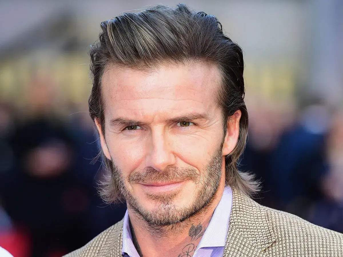 David Beckham con su icónica media melena, un estilo que inspira a muchos hombres sobre como dejarse media melena hombre.