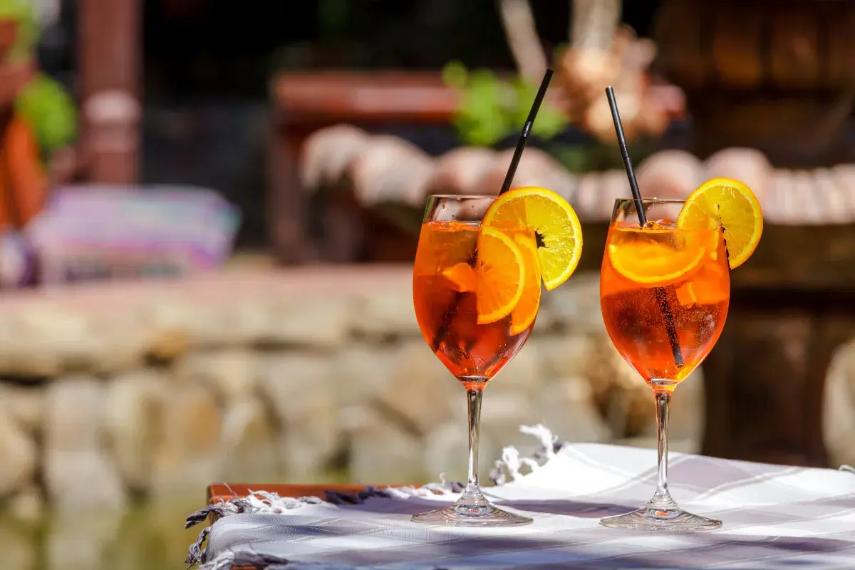 Dwa Aperol Spritz z pomarańczą i cytryną, idealne na lato. Prosty aperol spritz przepis na orzeźwiający drink.