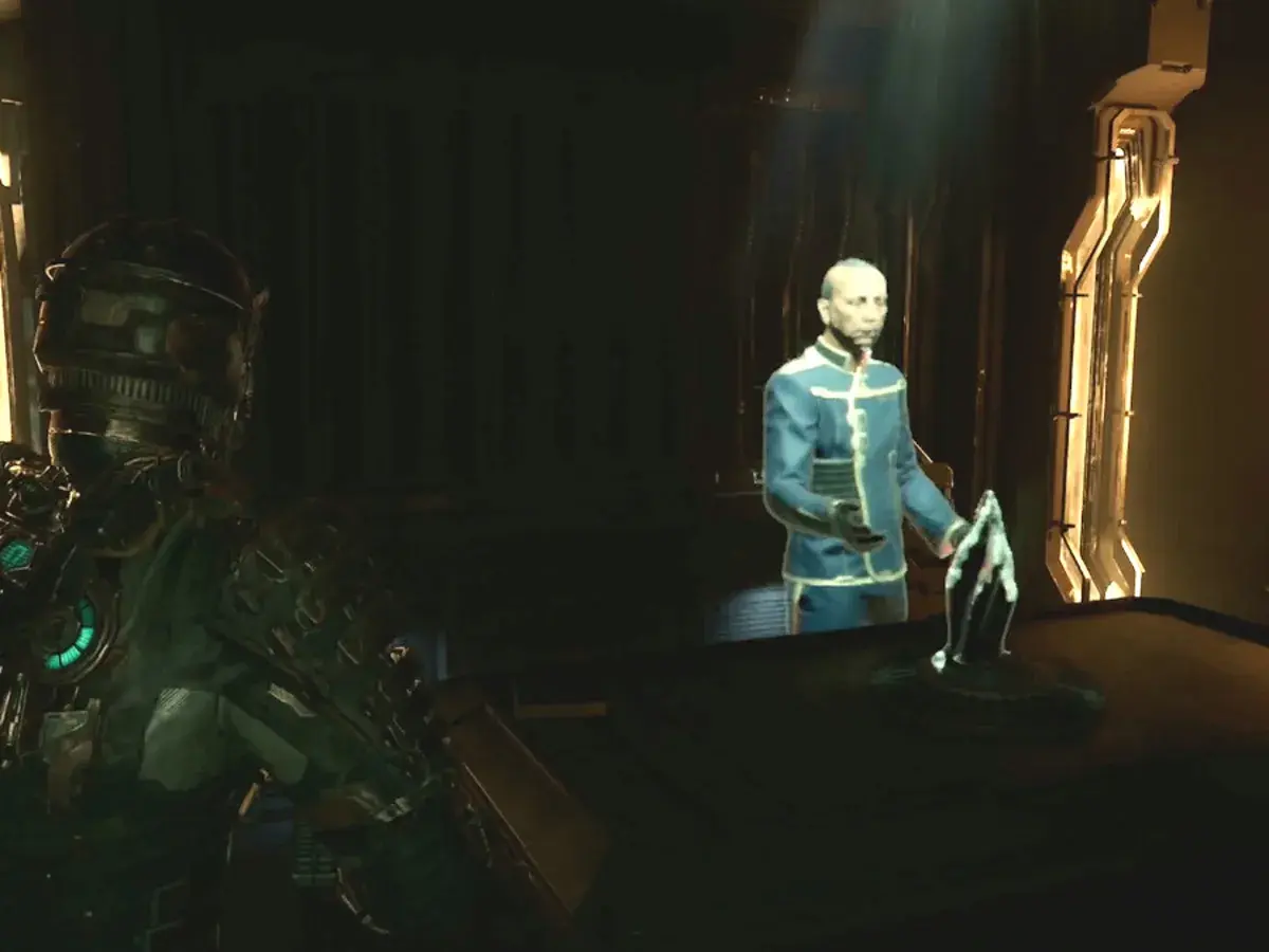 Isaac w zbroi patrzy na hologram doktora w Dead Space Remake. Poradnik pomoże Ci przetrwać.