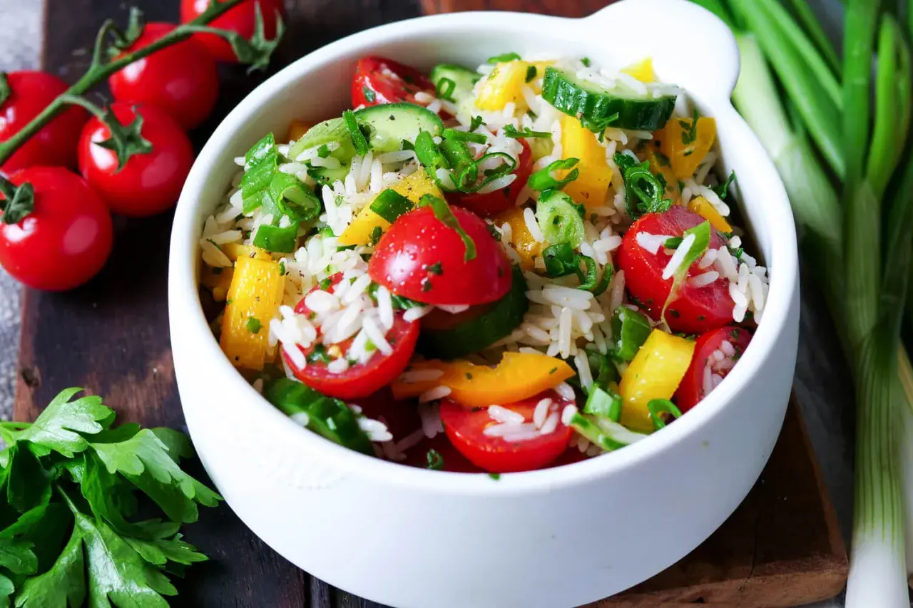 Frischer Reissalat mit Tomaten, Gurken und Paprika. Ein leichtes und gesundes reissalat rezept für den Sommer.