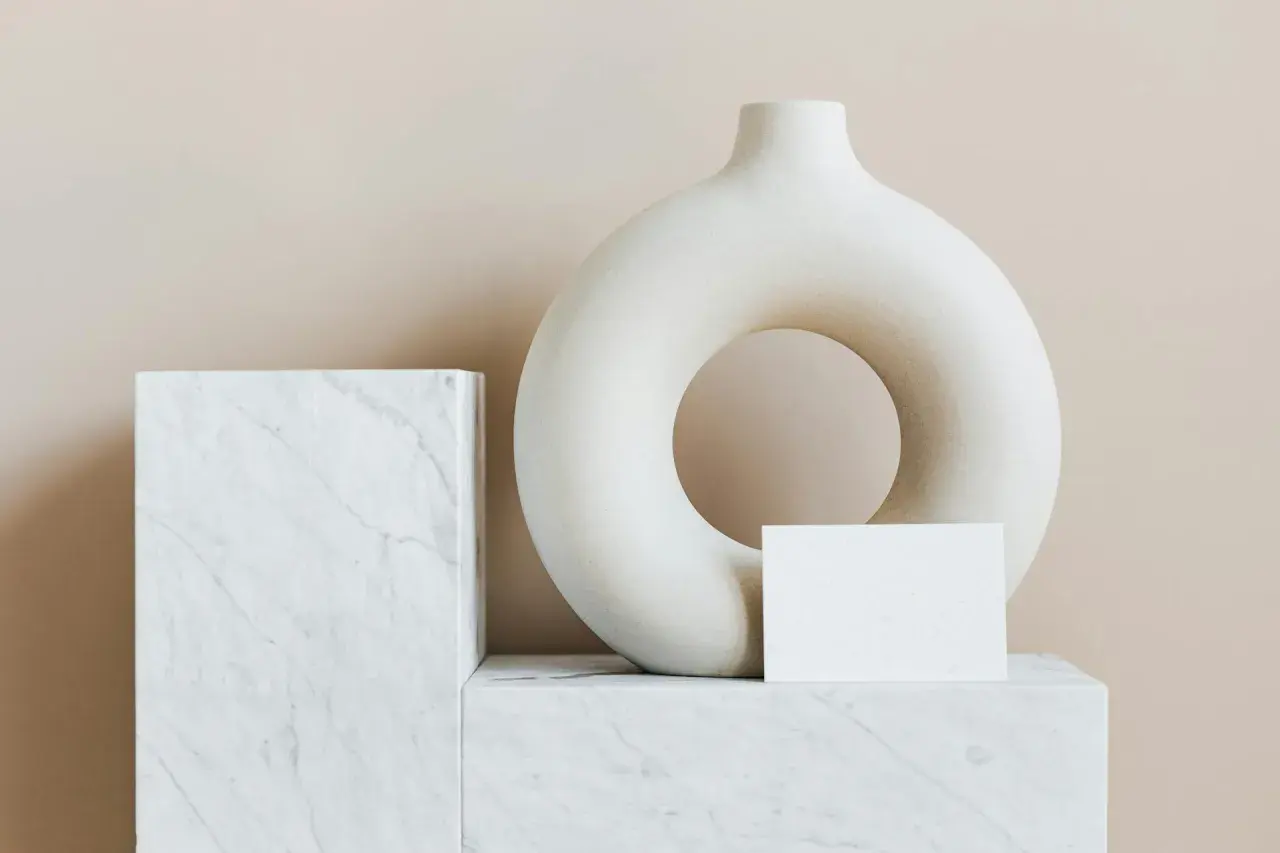 A torus-shaped vase and marble blocks, evoking minimalist famous modern art.