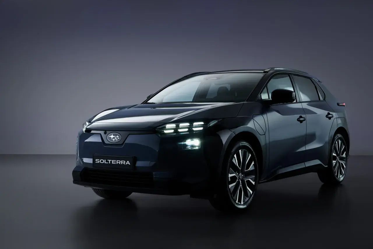 Ciemnogranatowy Subaru Solterra z włączonymi światłami LED, prezentujący nowoczesny design SUV-a elektrycznego.