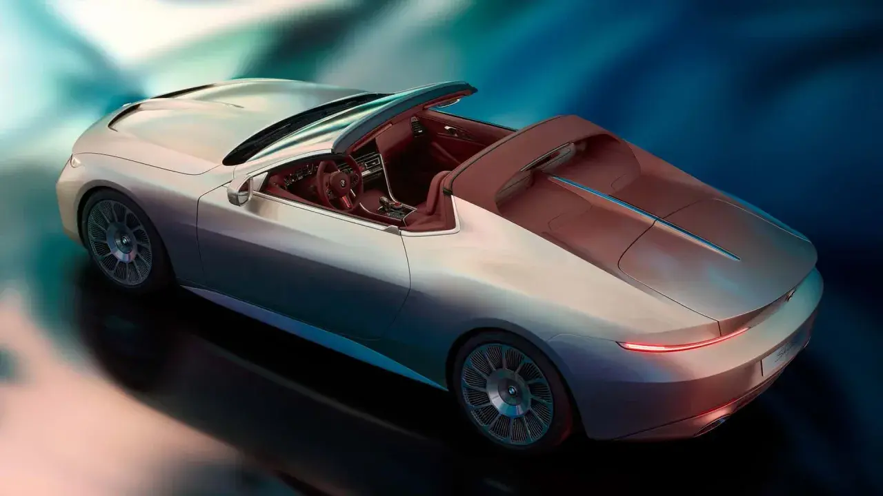 Lussuosa BMW Skytop cabriolet color argento con interni in pelle rossa, su sfondo blu sfumato.