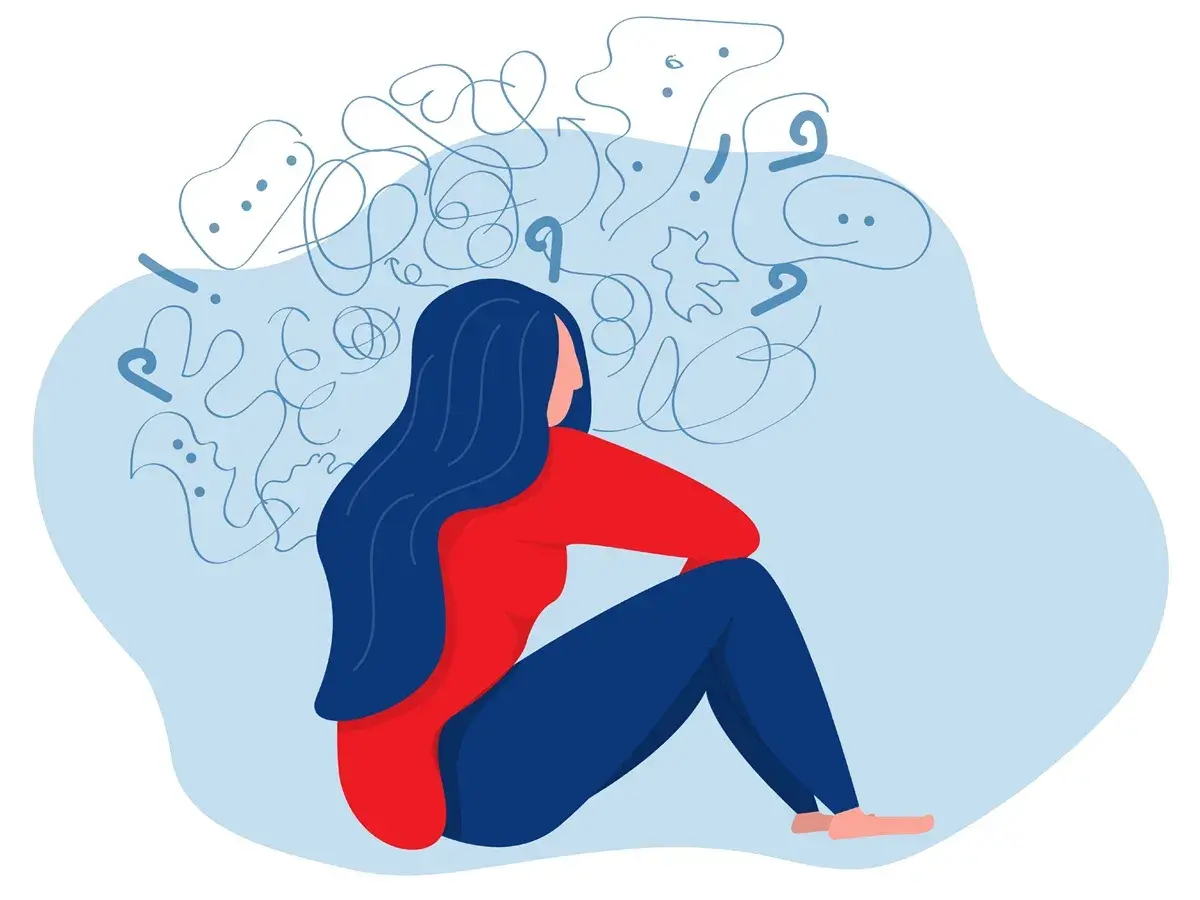 En person sitter med huvudet i händerna, omgiven av kaos. Kan en psykolog sjukskriva? Ja, vid psykisk ohälsa.