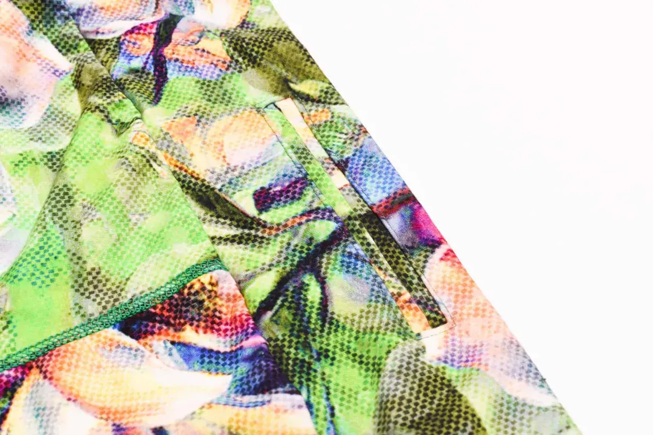 Close-up of a pocket on colorful floral leggings, showing how to add pockets to leggings with neat stitching.