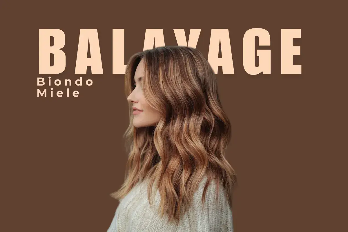 Balayage con riflessi biondo miele dorato su base castana. Capelli mossi e luminosi, un look naturale e chic.