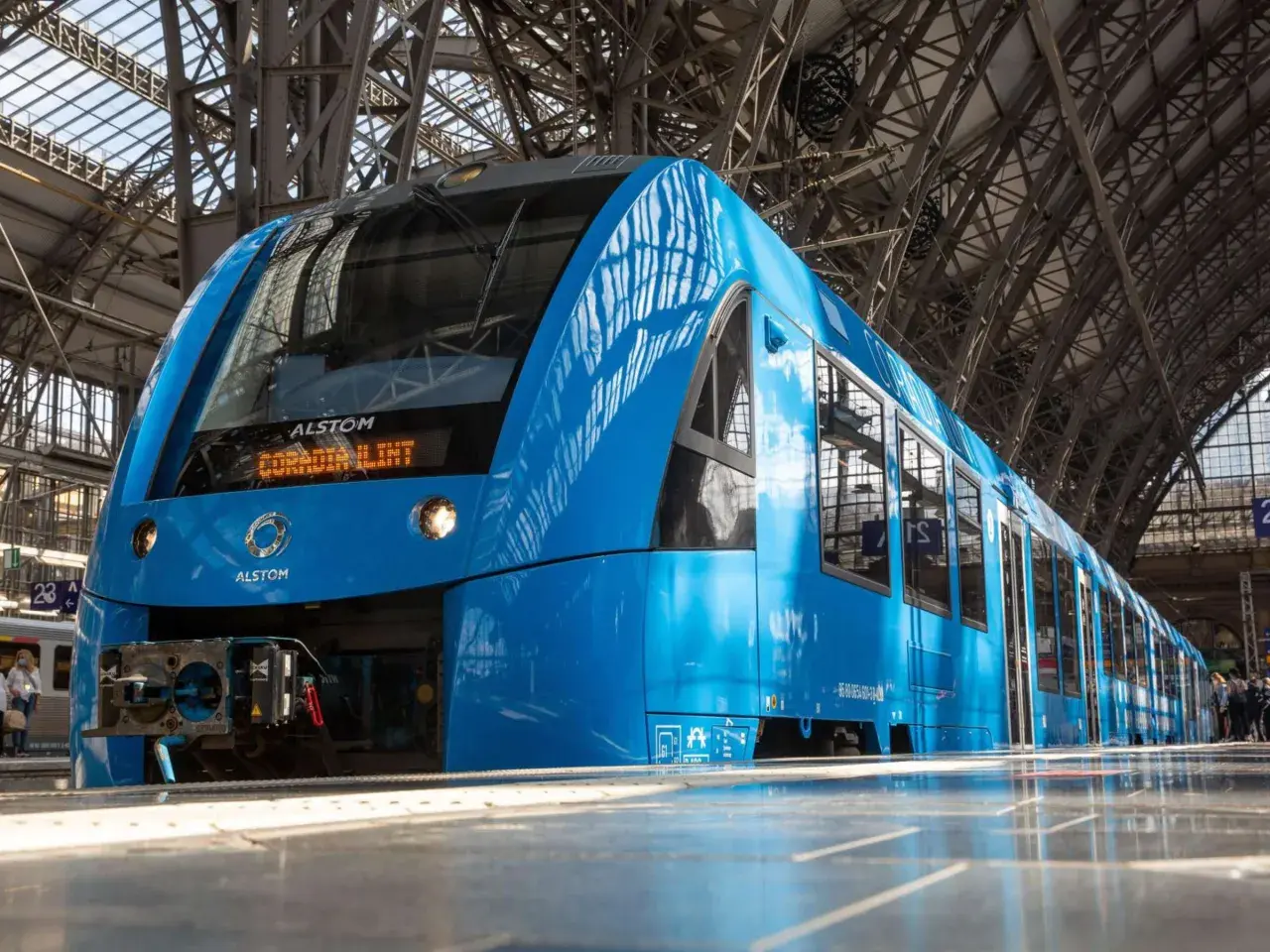 Ein blauer Alstom Coradia Lint Regionalzug steht im Bahnhof.