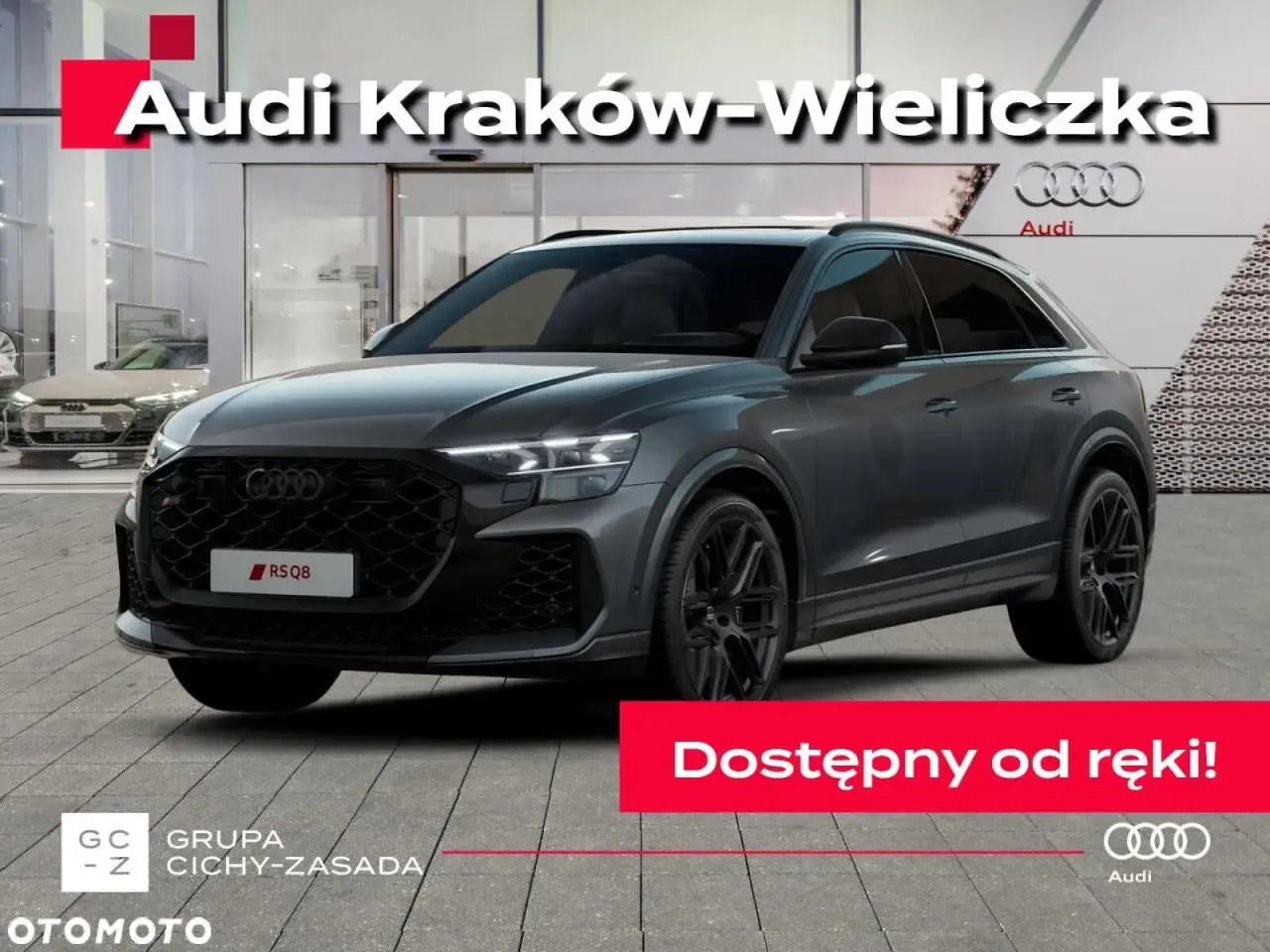 Szary Audi RS Q8 przed salonem Audi Kraków-Wieliczka. Sprawdź aktualną audi rsq8 cena i dostępność od ręki!