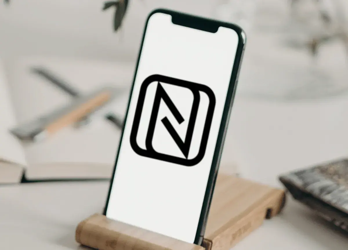 Na ekranie telefonu widnieje ikona NFC. To symbol, który informuje o możliwości zbliżeniowej komunikacji między urządzeniami.