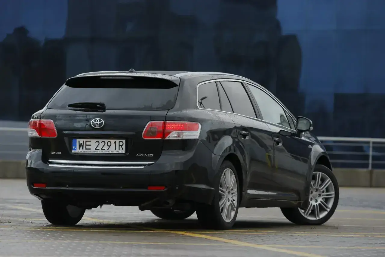 Czarne kombi Toyota Avensis T27 z polskimi tablicami WE 2291R. Widać tylne światła i felgi.