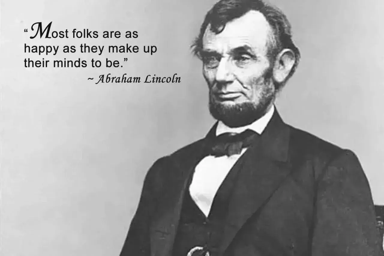Ritratto di Abraham Lincoln con la citazione "Most folks are as happy as they make up their minds to be." - frasi sull'arte in inglese.