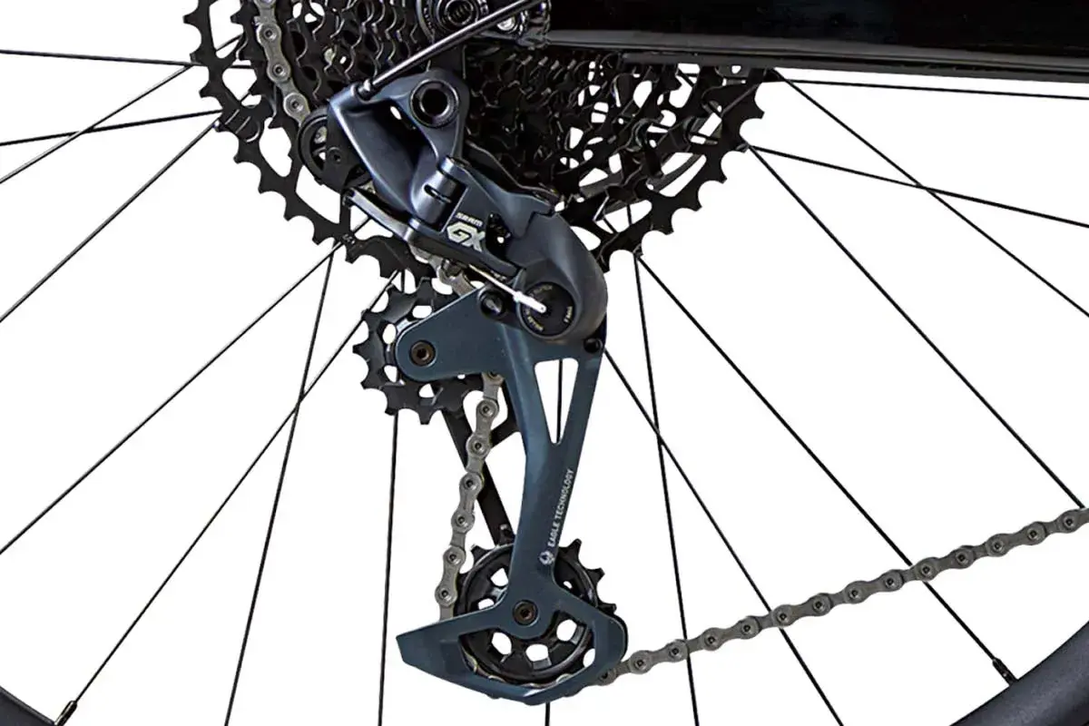 Close-up of a bicycle's rear derailleur with a bent derailleur hanger, showing the cassette and chain.