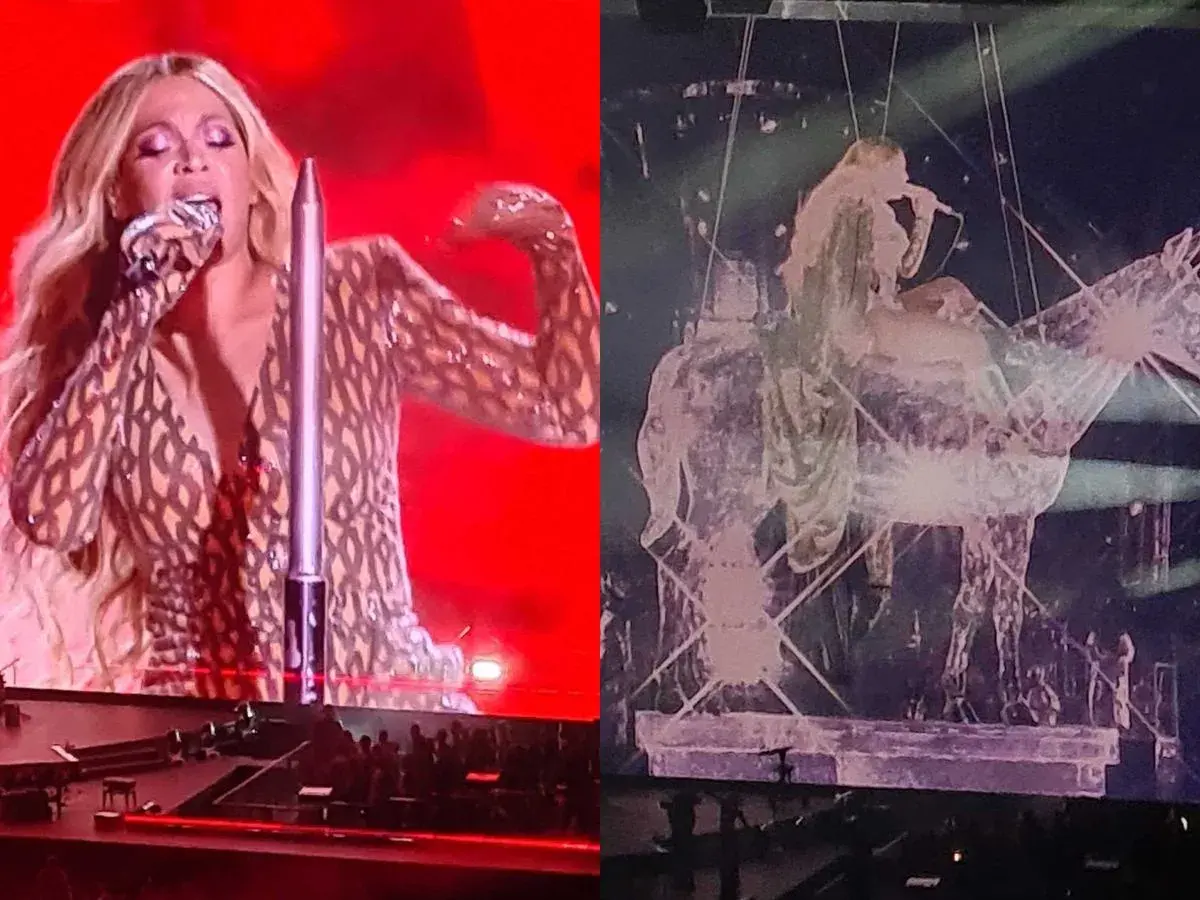 Beyoncé w błyszczącym stroju śpiewa na scenie, a obok niej widać jej sylwetkę na tle scenografii w kształcie konia. Niezapomniany koncert!