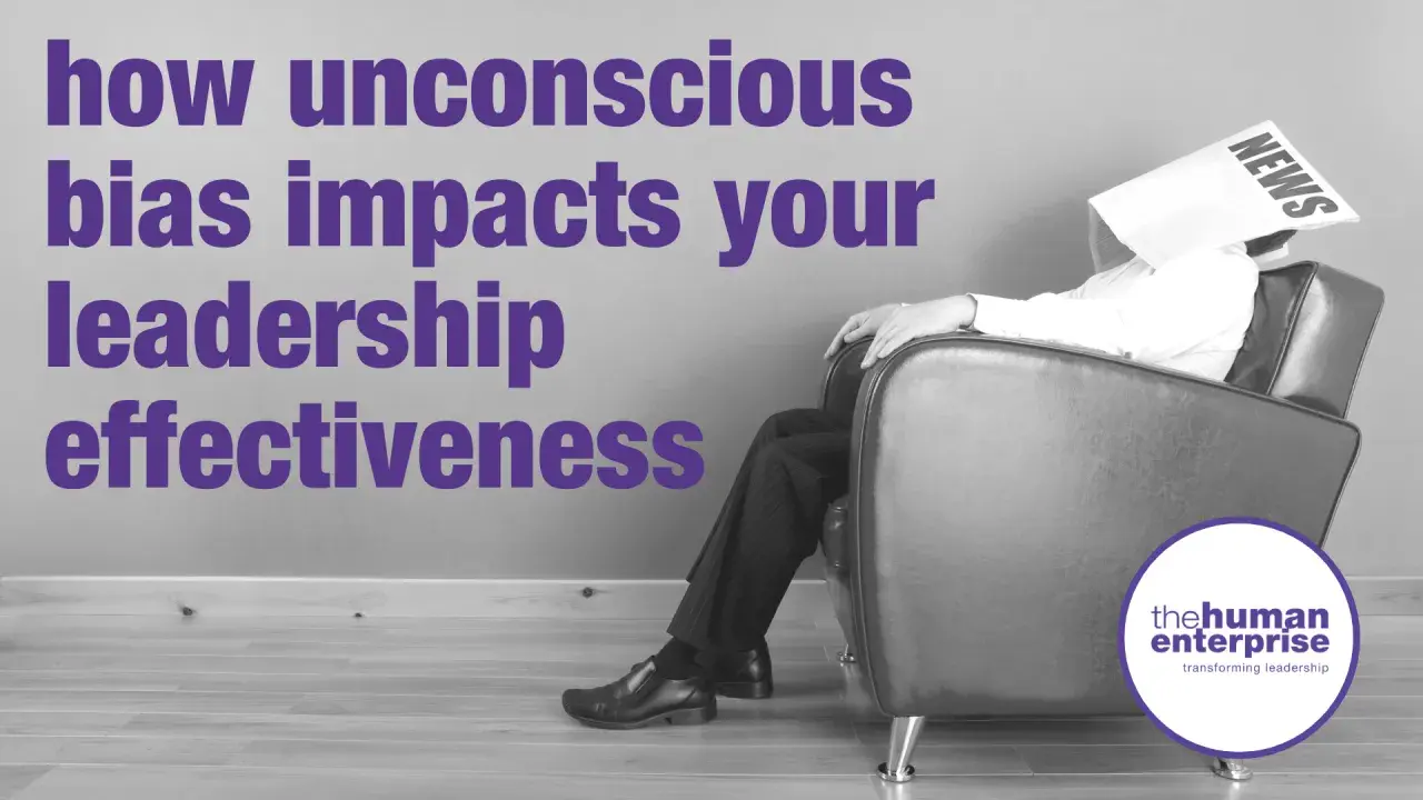 A man sits with a newspaper over his head, symbolizing how unconscious bias coaching can improve leadership effectiveness.