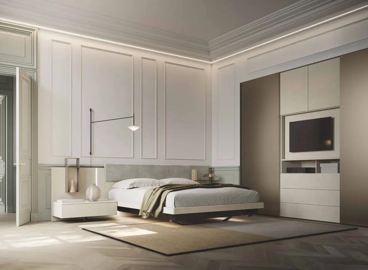 Modern bedroom with a bed, nightstand, wardrobe with TV, and elegant wall paneling.