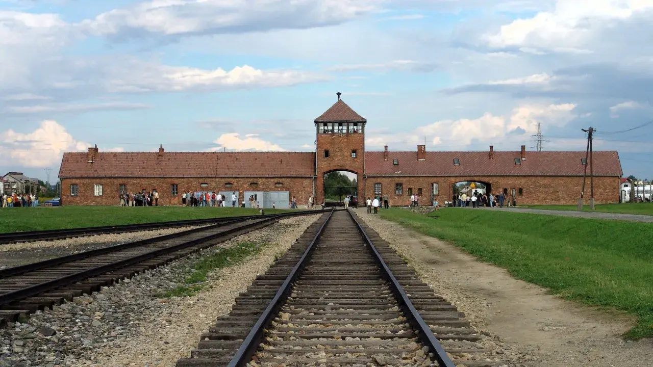 Brama obozowa Auschwitz, gdzie kiedyś przybywały pociągi z ludźmi.