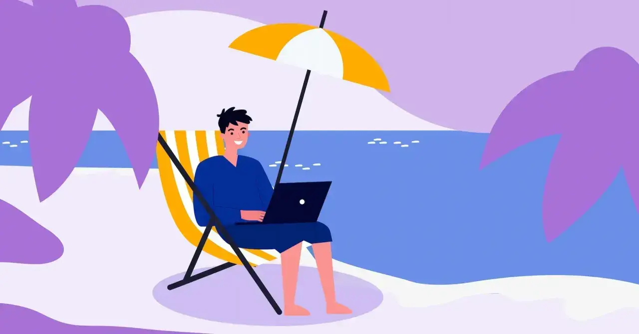 Mężczyzna pracuje na laptopie na plaży pod parasolem. Idealne miejsce na urlop, od kiedy 35 dni urlopu to norma.
