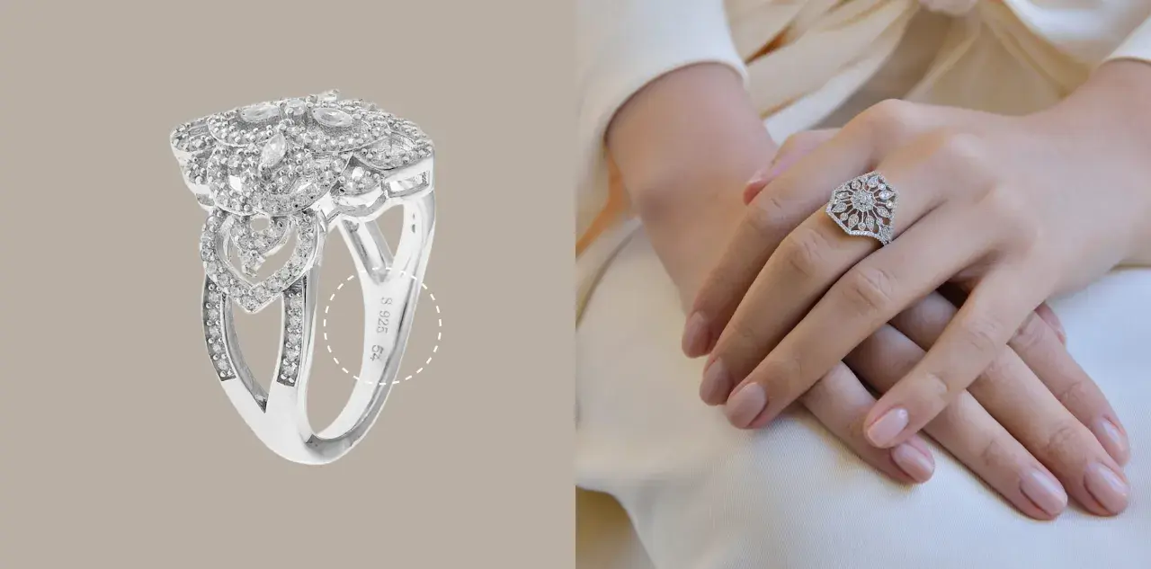 Anillo de plata 925 con incrustaciones de diamantes, con un diseño floral y de corazones. La marca de plata 925 es visible.