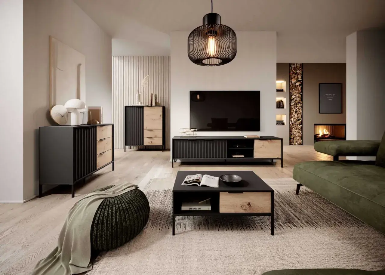 Nowoczesny salon z meblami w kolorze dąb Wotan, czerni i zieleni. Wygodna sofa, stolik kawowy i komoda tworzą przytulną przestrzeń.