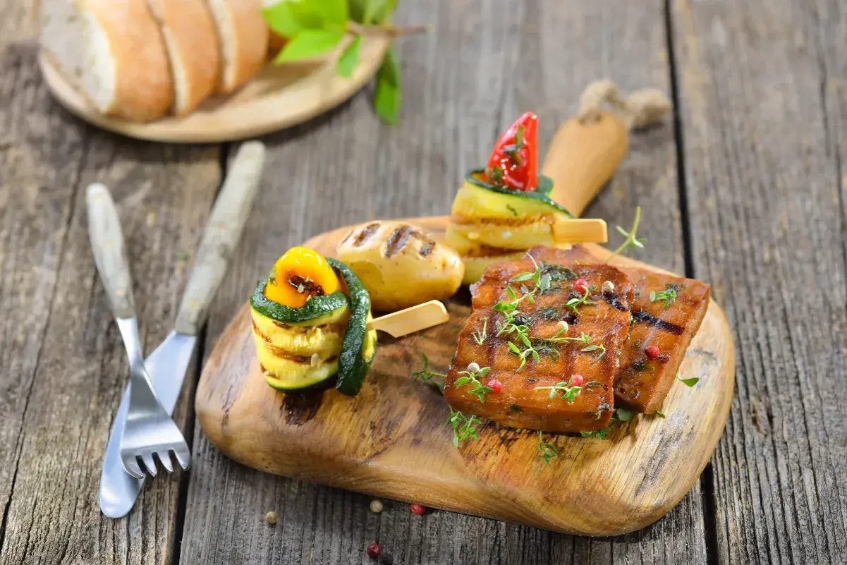 Seitan grigliato con verdure e patate, un piatto gustoso che evidenzia i **seitan valori nutrizionali** per un pasto sano.
