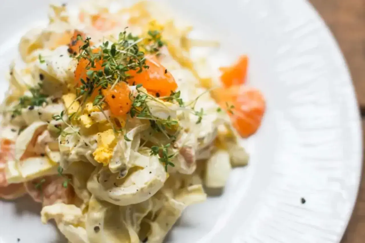 Cremiger Chicorée Salat mit Ei, Orange und frischen Kräutern, verfeinert mit Pfeffer. Ein leichter Genuss.