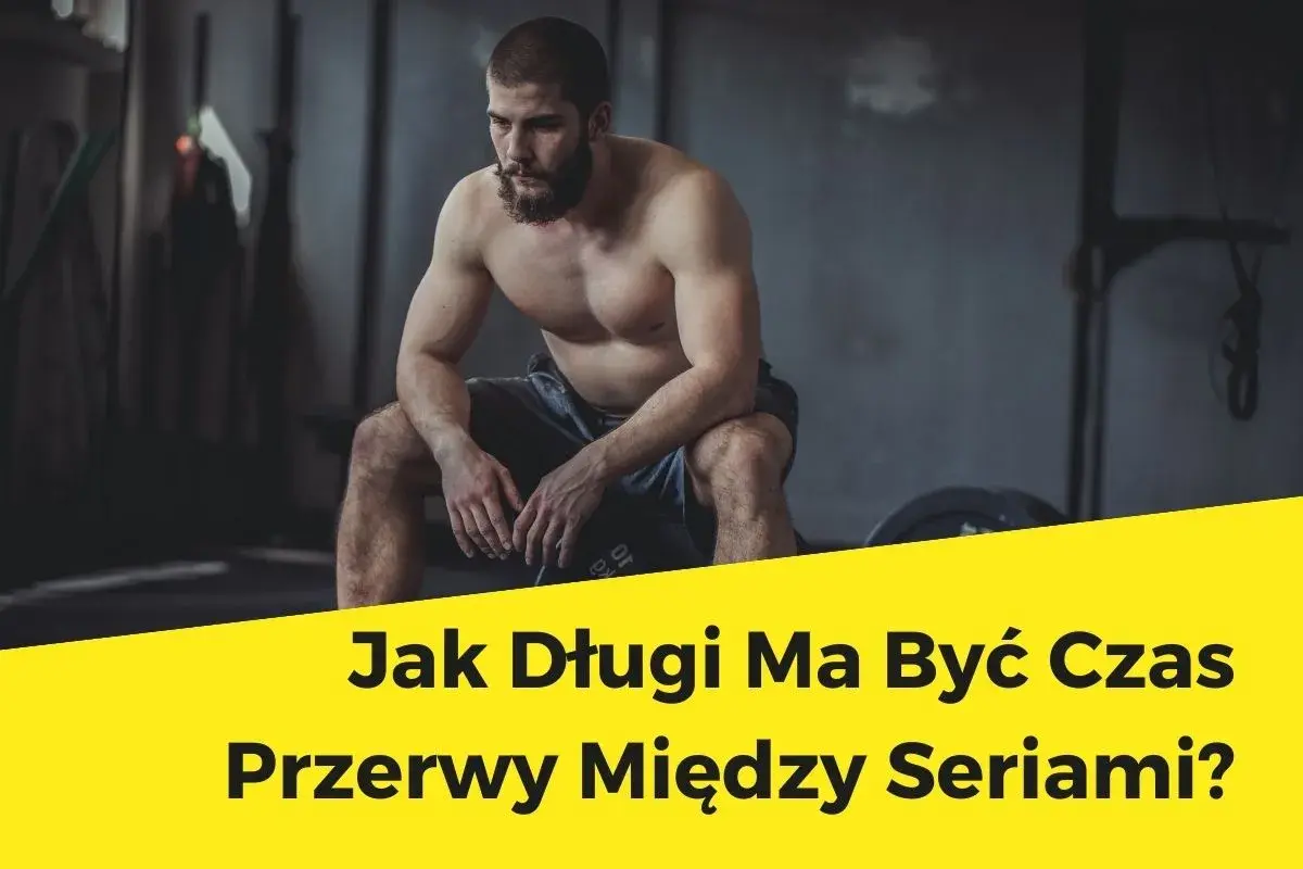 Mężczyzna w siłowni odpoczywa, zastanawiając się, ile przerwy między seriami jest optymalne.