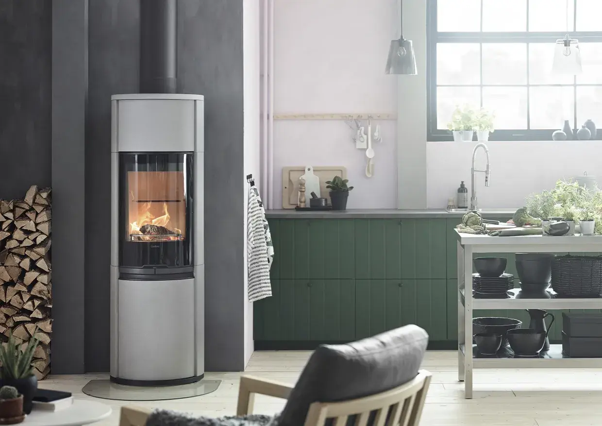 En modern braskamin ger värme och mysfaktor i ett stilrent kök. Installera braskamin för en ombonad känsla.