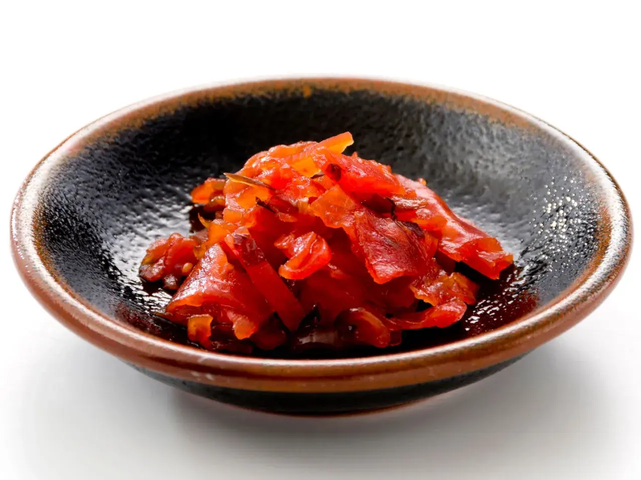 A small bowl of bright red fukujinzuke, a relish often served with Japanese curry. This image could be part of a fukujinzuke recipe.