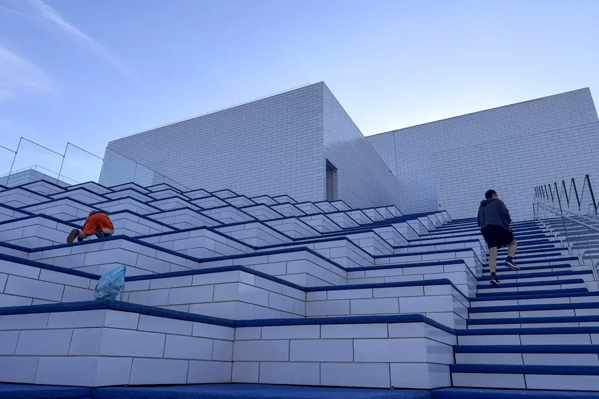 Dzieci bawią się na schodach przed budynkiem Lego House w Billund.