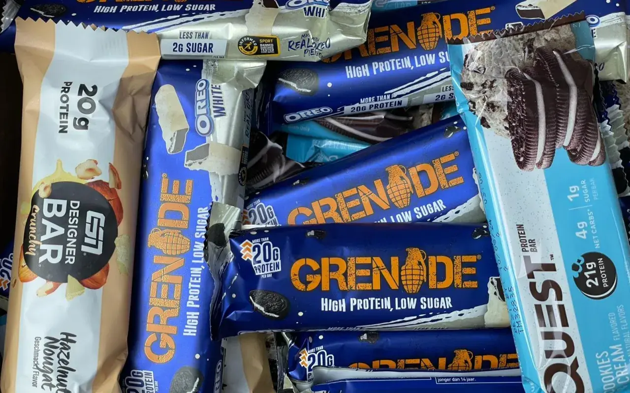 Ein bunter Haufen von Proteinriegeln, darunter Grenade und Quest. Ein Powerriegel-Test für Sportler.
