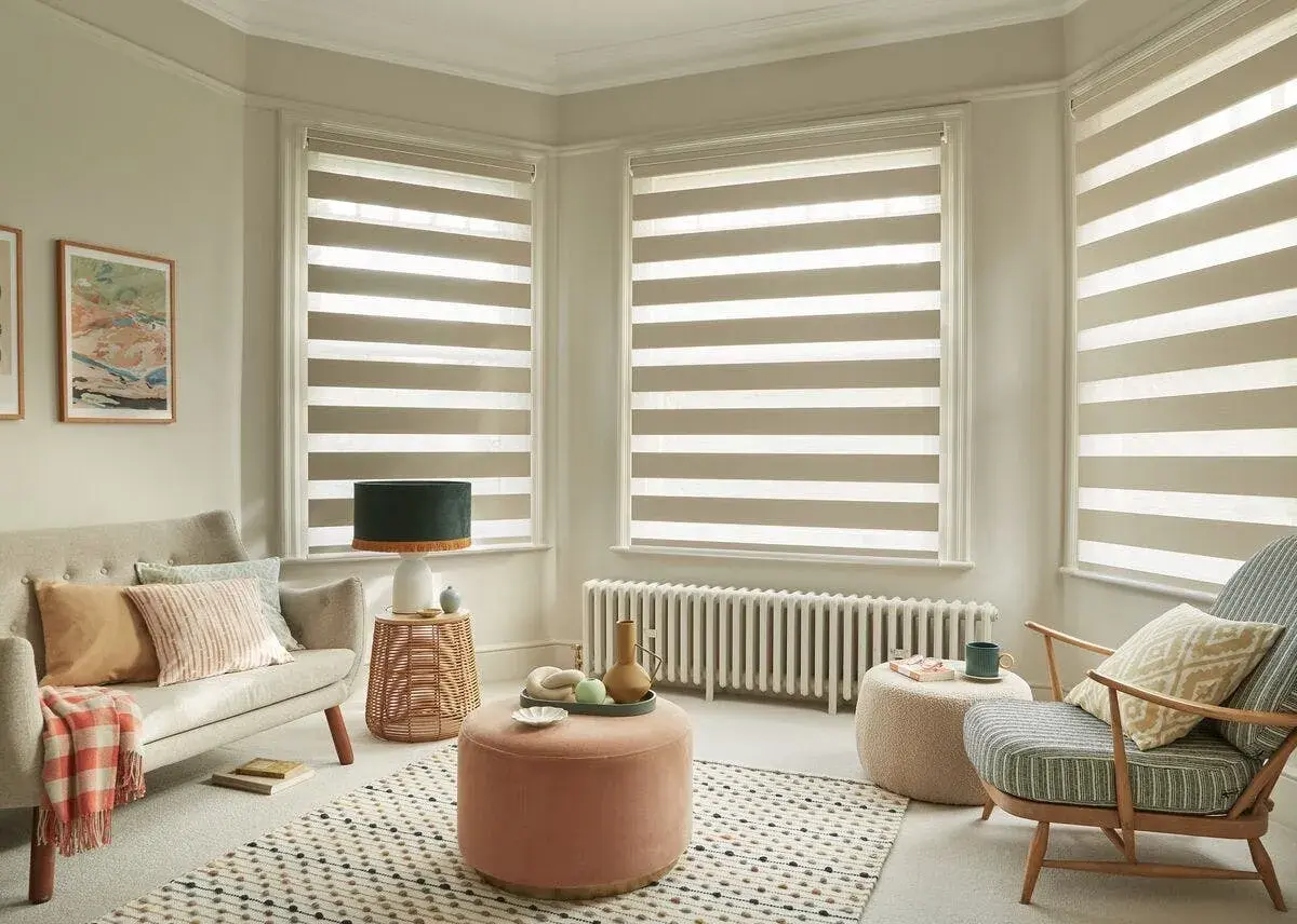 Modern living room with striped roller blinds, offering a stylish way to choose best window coverings.