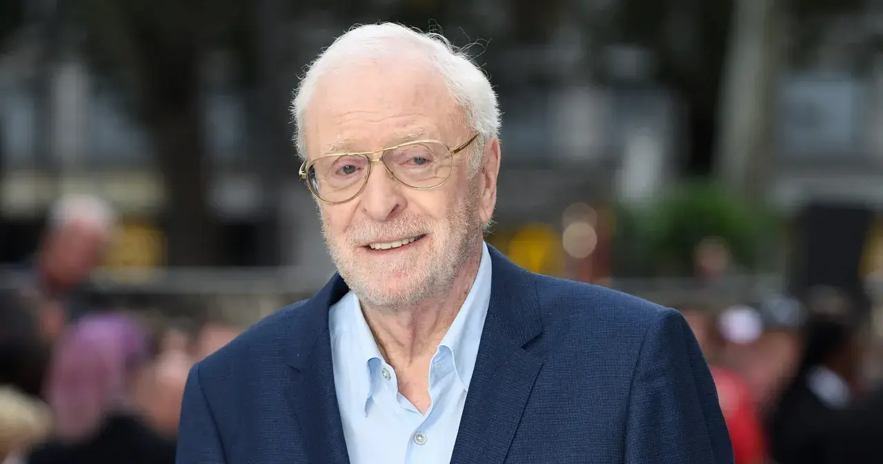 Uśmiechnięty Michael Caine w okularach, ikona kina. Jego niezapomniane role w licznych filmach na zawsze zapisały się w historii.