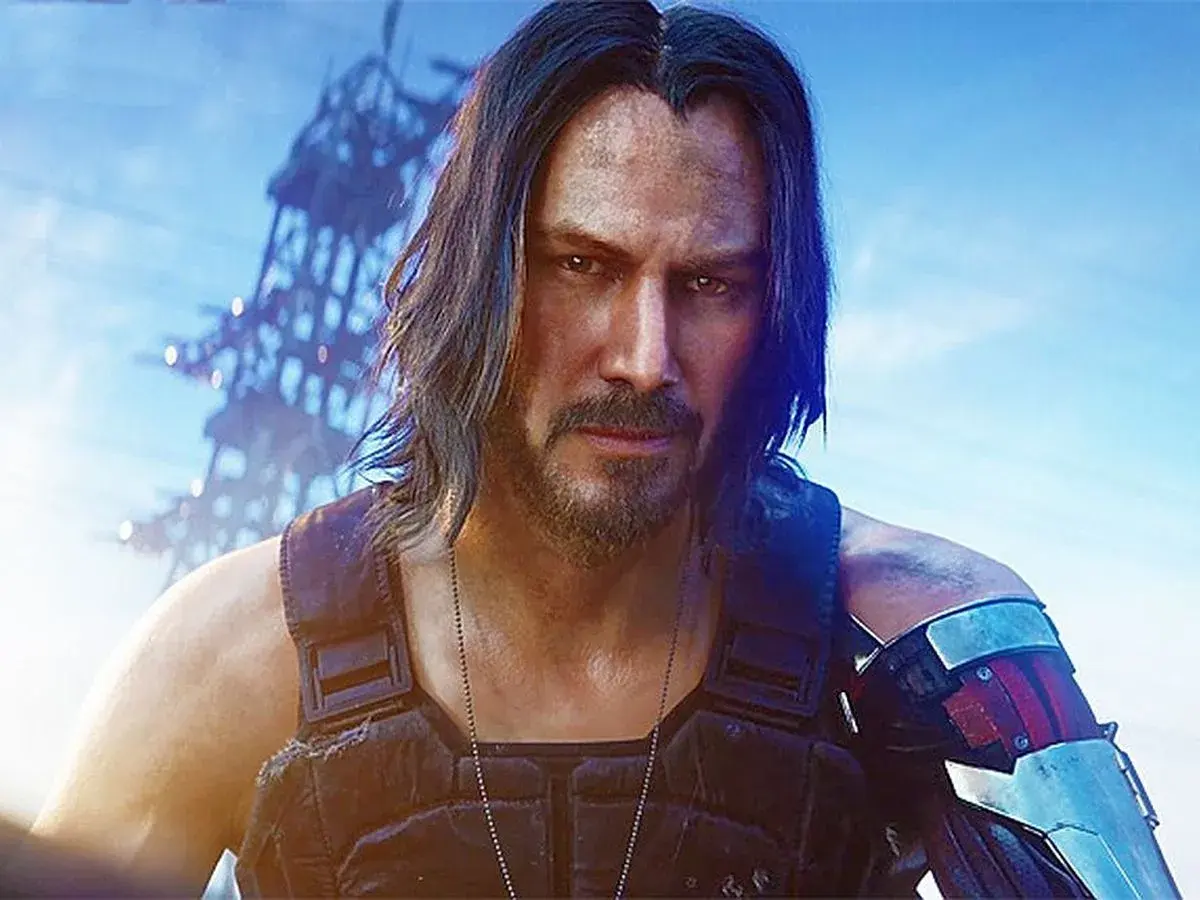 Keanu Reeves jako Johnny Silverhand w Cyberpunk 2077. Postapokaliptyczny krajobraz w tle.