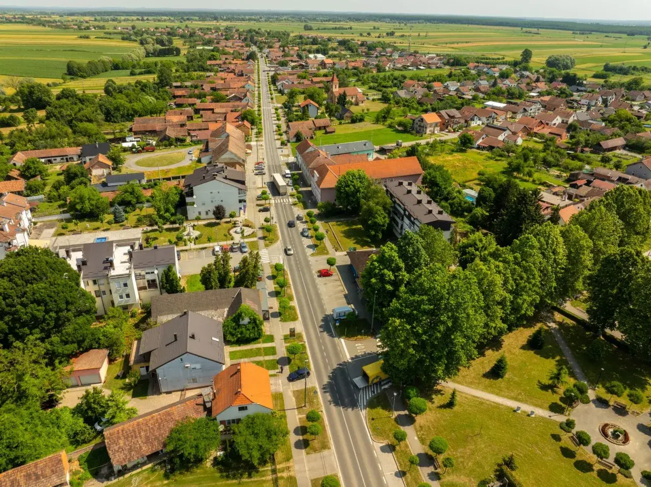 Widok z lotu ptaka na spokojne miasteczko, gdzie zielone pola przeplatają się z dachami domów. Odkryj urokliwe śrem atrakcje i poczuj atmosferę sielskiego życia.