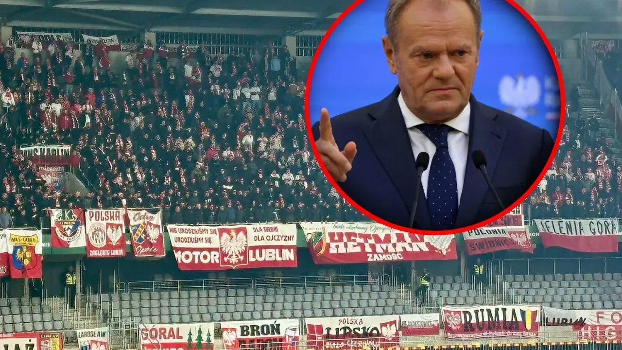 Tłum kibiców na stadionie z transparentami "Polska" i "Lublin", w tle Donald Tusk. Litwa – Polska.